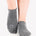 Women wearing gray grip socks with white smiley face for Pilates, Barre, Yoga, and beyond. 