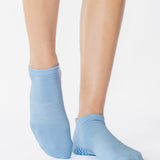 Women wearing a solid light blue full foot grip sock made for Pilates, Barre, Yoga, and beyond. 