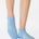 Women wearing a solid light blue full foot grip sock made for Pilates, Barre, Yoga, and beyond. 