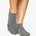 Women wearing a solid gray full foot grip sock made for Pilates, Barre, Yoga, and beyond. 