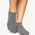 Women wearing a solid gray full foot grip sock made for Pilates, Barre, Yoga, and beyond. 